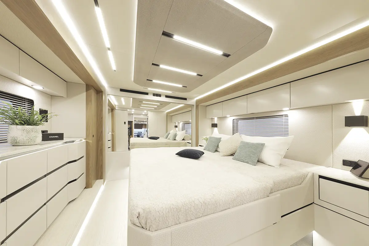 Sleek master bedroom interior inside the Vario mobile vehicle with a double bed, wooden accents, and integrated LED strip lighting